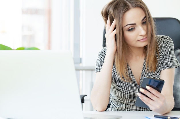 Happy business woman talking on mobile phone