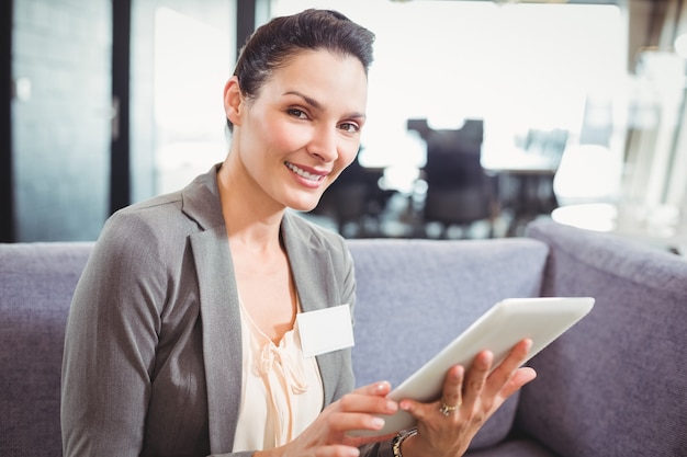 Happy business woman using digital tablet