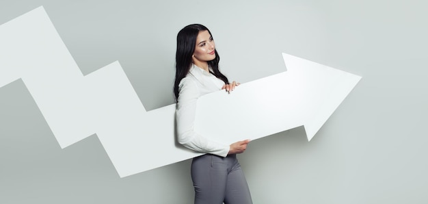 Happy Business Woman with White Empty Rising Arrow Representing Business Growth Shares Up Business Success and Profit Concept