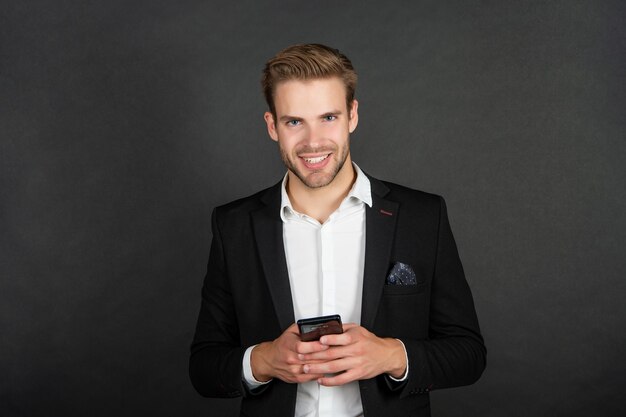 Happy businessman checking email on smartphone, agile business