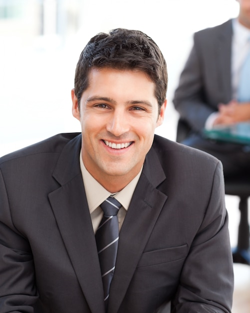 Happy businessman in the foreground during a meeting with a friend