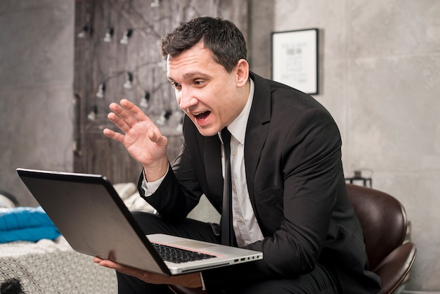 Photo happy businessman having video conference