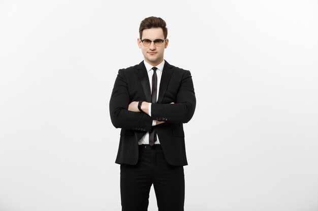 Happy businessman isolated - Successful handsome man standing with crossed arms isolated over white background.
