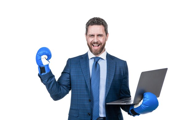 Happy businessman man in suit and boxing gloves hold laptop isolated on white online