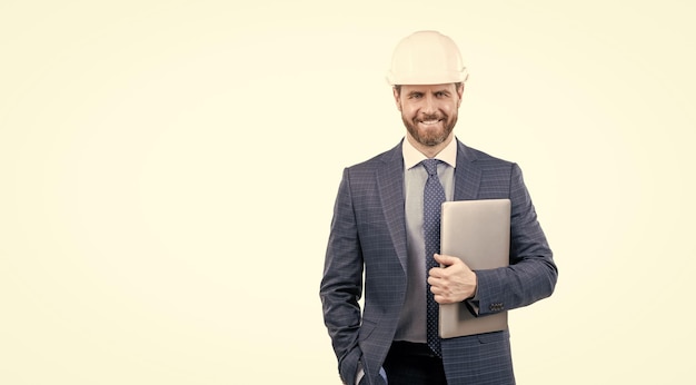 Happy businessman man in suit and safety helmet hold laptop isolated on white copy space safety business