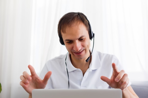 Happy Businessman in the office on the phone, headset, Skype. looking camera