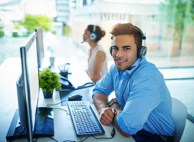 Happy businessman portrait and call center for customer service support or telemarketing at office friendly man person consultant or agent with smile on computer for online advice in contact us