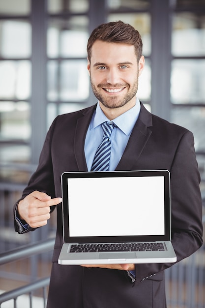 Happy businessman showing laptop