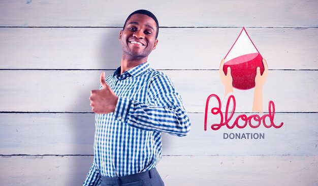 Happy businessman smiling at camera against blood donation