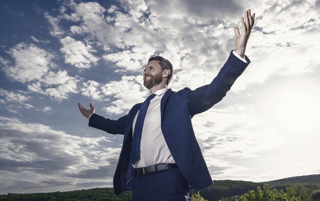 Happy businessman spreading arms wide open Professional businessman feel freedom