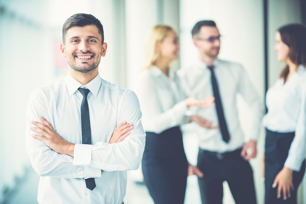 The happy businessman stand near partners