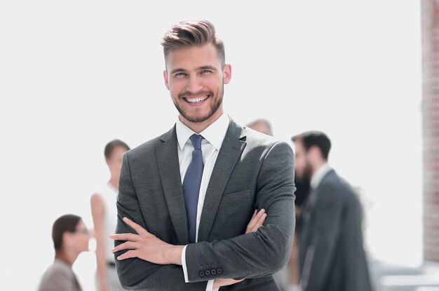 Happy businessman standing in modern office