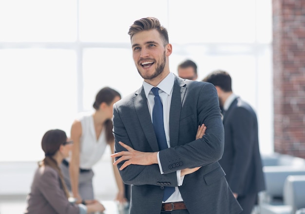 Happy businessman standing in modern officephoto with copy space