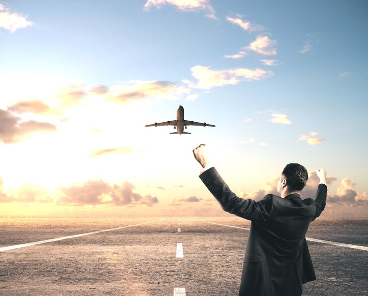 Happy businessman standing on runway