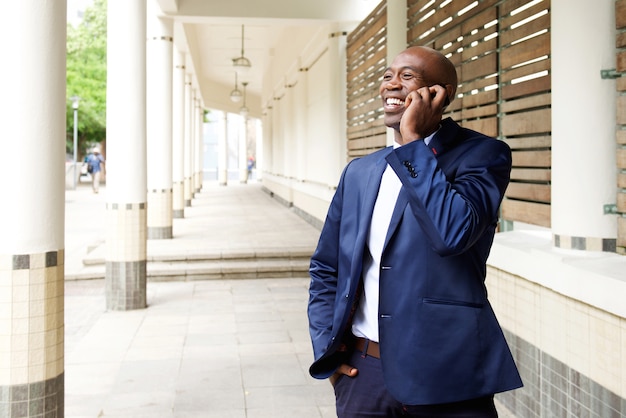 Happy businessman talking on the mobile phone