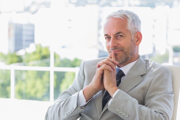 Happy businessman thinking