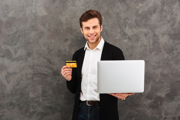 Happy businessman using laptop computer