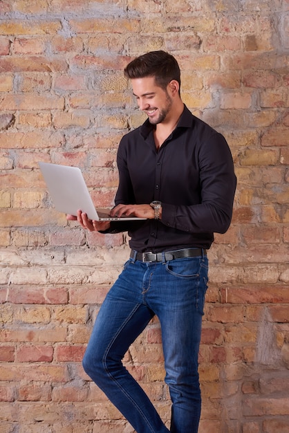 Happy businessman using laptop