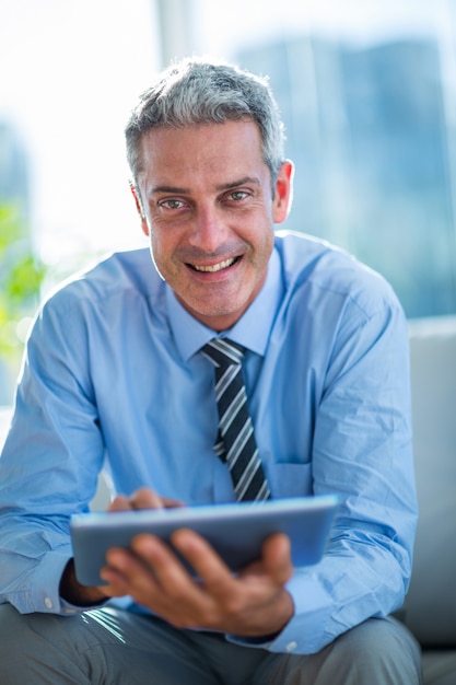 Happy businessman using tablet computer 