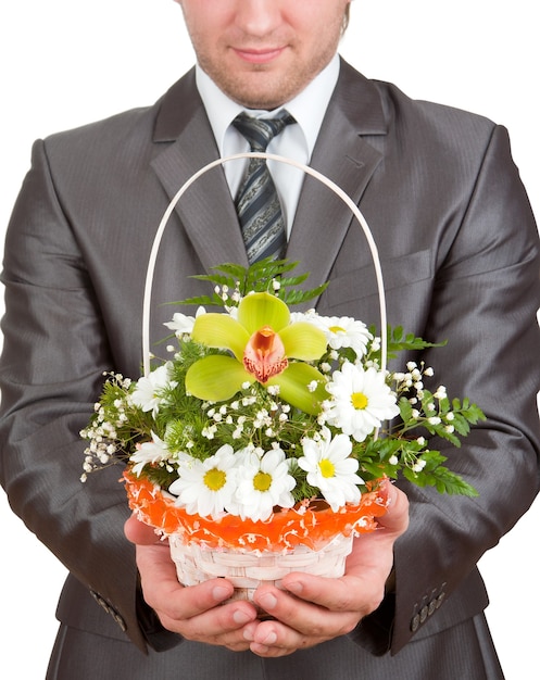 Happy businessman with basket of flowers