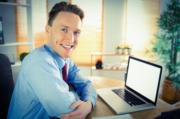 Happy businessman working with laptop