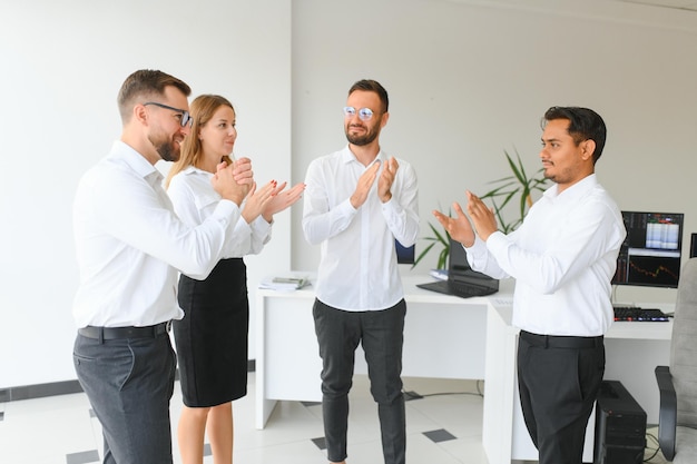 Happy businesspeople laughing while collaborating on a new project in an office Group of diverse business people working together in a modern workspace