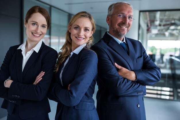 Happy businesspeople standing in office