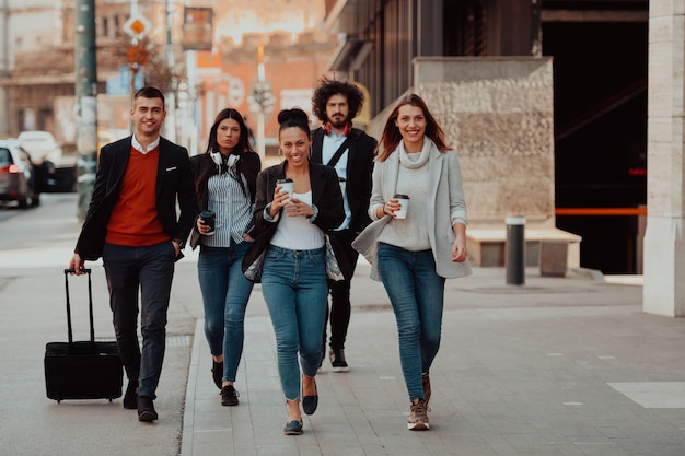 Happy businesspeople walk in the street after a successful day of work and discuss the closed deals. High quality photo