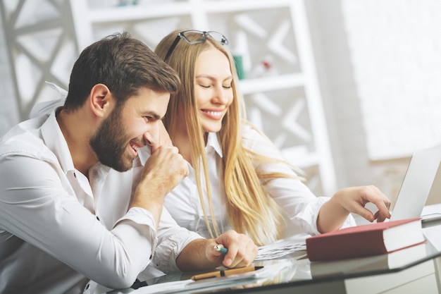 Happy businesspeople working on project