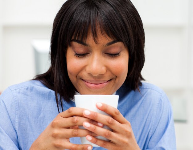 Happy businesswoman drinking a coffee