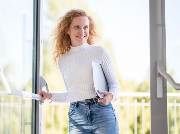 Happy businesswoman entering the building