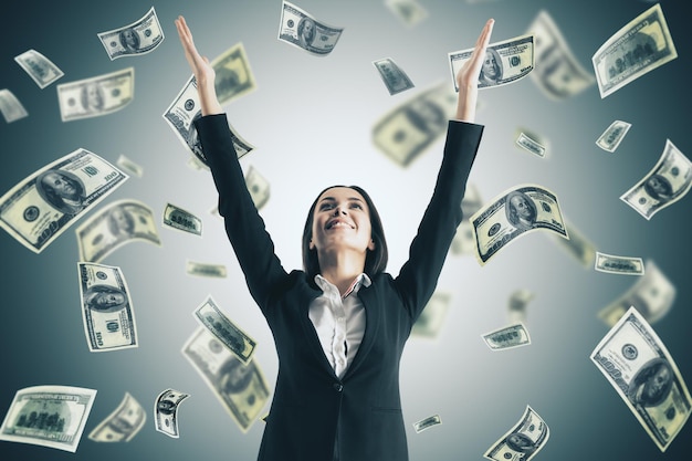 happy businesswoman and falling dollar bills