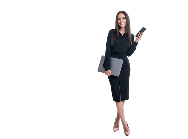 Happy businesswoman holding mobile phone and laptop Business communication Mobile technology