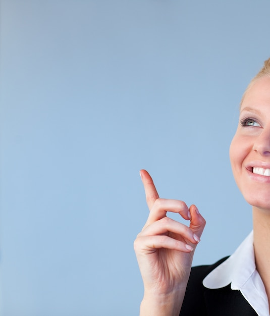 Happy Businesswoman pointing upwards