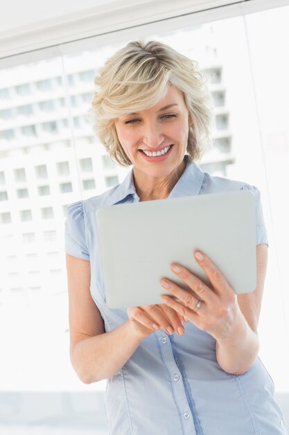 Happy businesswoman using digital tablet