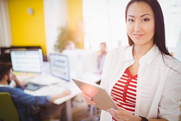 happy businesswoman using tablet computer at creative office