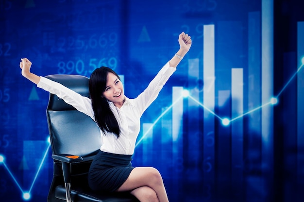 Happy businesswoman with stock market trading or company investment growth