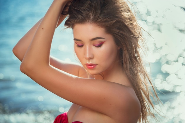 Happy Carefree Woman Enjoying Beautiful Sunset on the Beach.