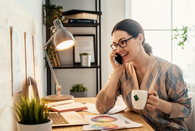 Happy casual beautiful woman working on a laptop at home.