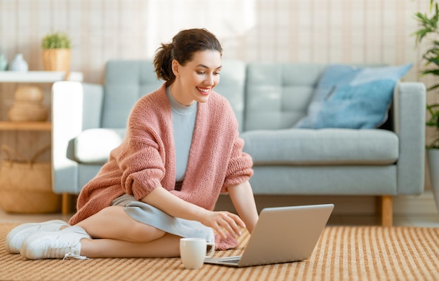 Happy casual beautiful woman working on a laptop at home.