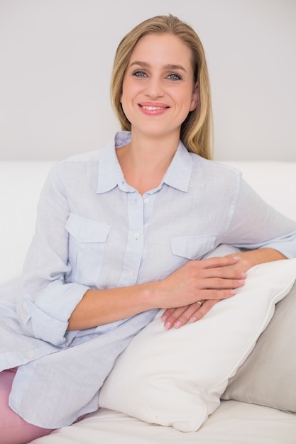 Happy casual blonde relaxing on couch