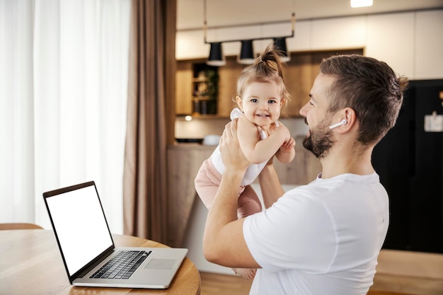 A happy casual businessman is playing with his daughter on a break