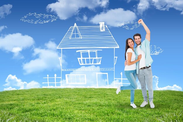 Happy casual couple cheering at camera against blue sky over green field