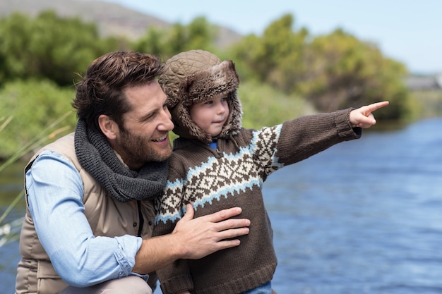 Happy casual father and son at a lake