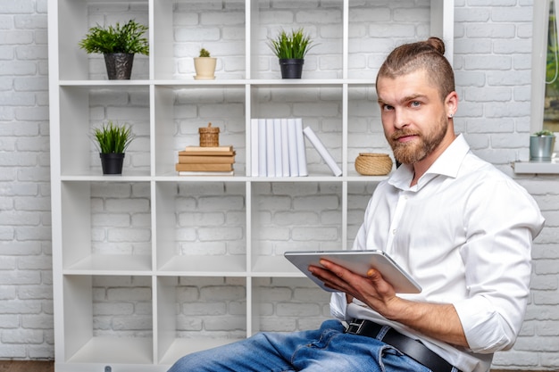 Happy casual man using tablet computer