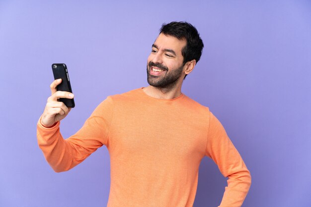 Happy casual man with smartphone