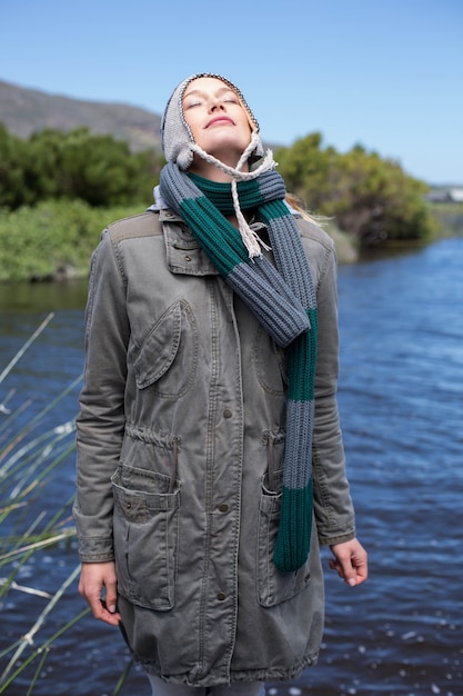 Happy casual woman at a lake