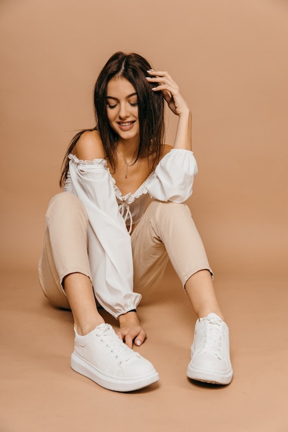 Happy casual woman lying on the floor over pastel background. Lady, cute. Provence concept. High quality photo. High quality photo