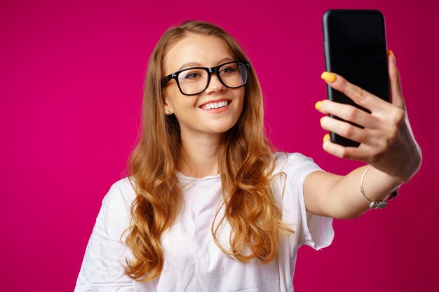 Happy casual young woman smiling and having a video call