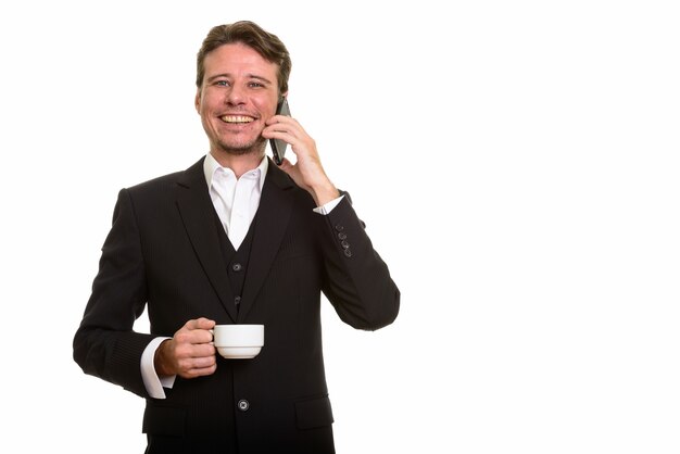 Happy Caucasian businessman talking on mobile phone